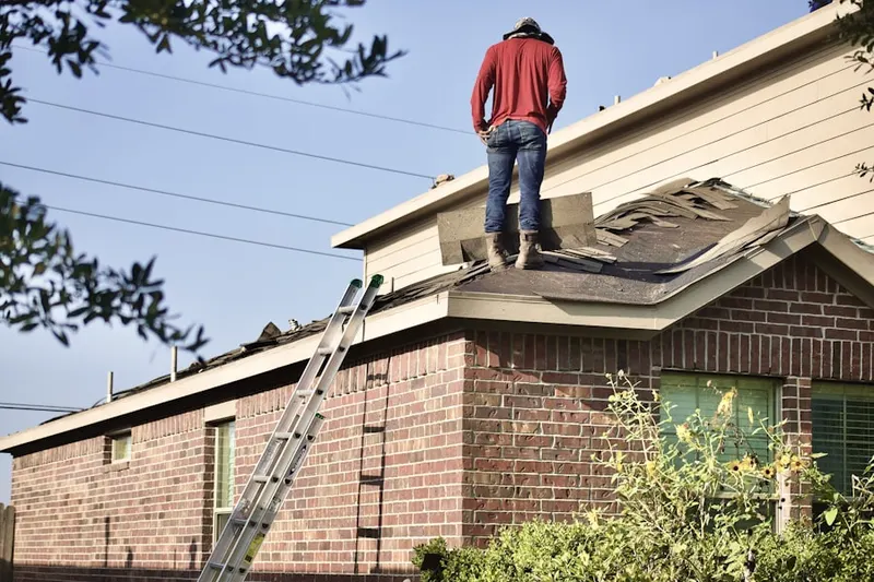 Professional roofer working on a residential roof in Upper Mohawk